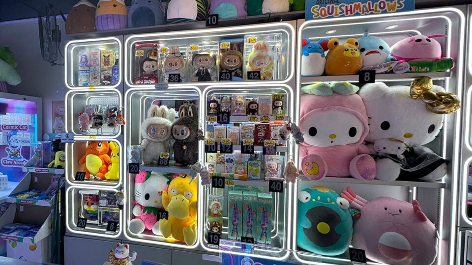 Switchable plush prizes displayed at checkout inside Cosmic Cat Claw Arcade.