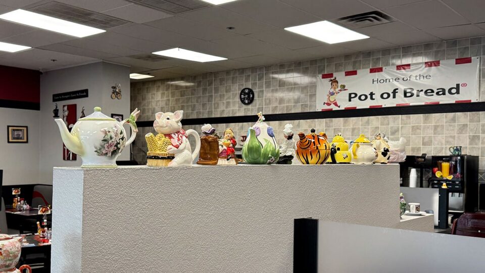 Decorative teapots displayed on the wall inside Jamms Restaurant