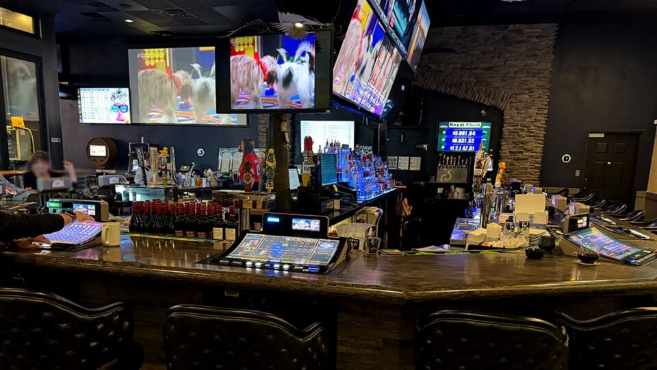 Bar area inside Sagos Tavern with video poker gaming machines and TVs for sports.