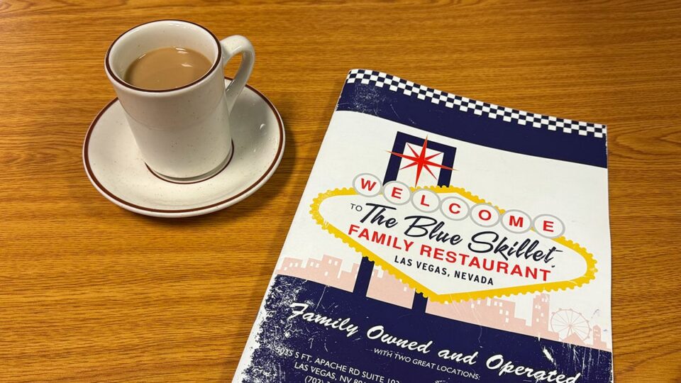 The Blue Skillet menu with a cup of coffee on the table at the Las Vegas diner.