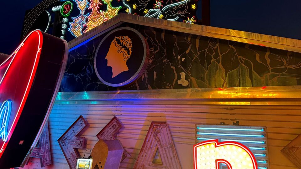 Vintage Caesars Palace neon sign with original Roman symbol backdrop