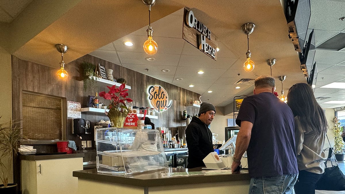 Front service counter inside Solo Qui café on Lake Mead featuring the espresso bar and gelato display.