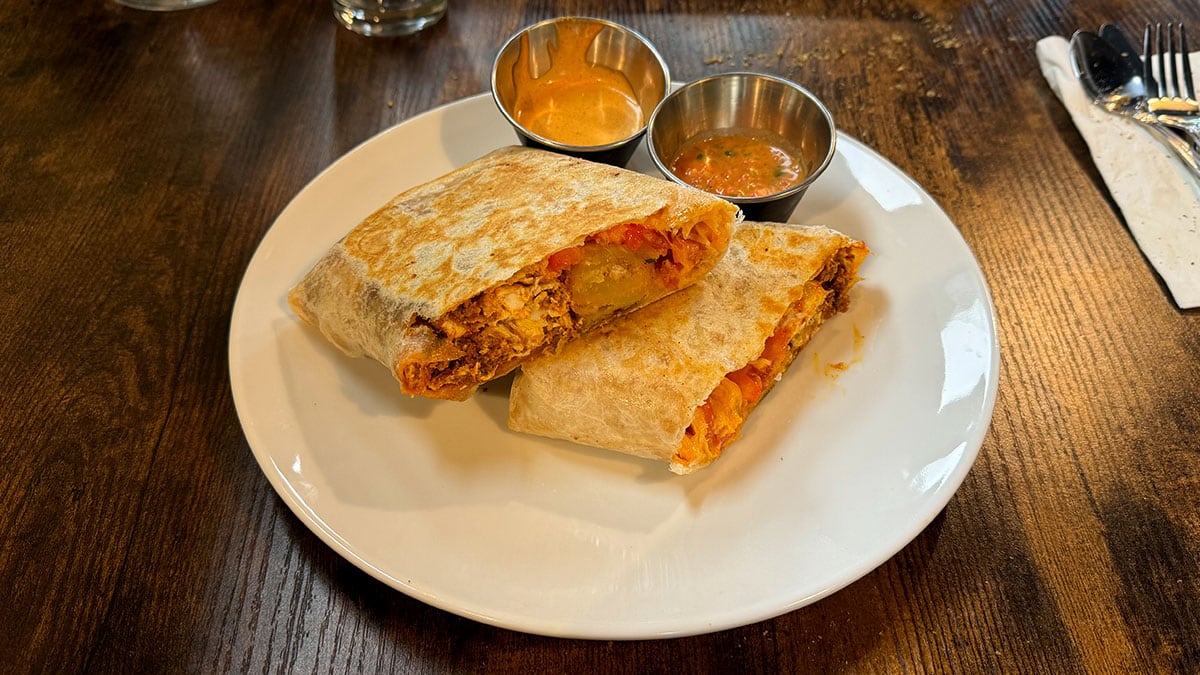 Crispy smash burritos topped with sunny-side eggs, melted cheese, fresh tomatoes, and chipotle drizzle, served with pico de gallo.