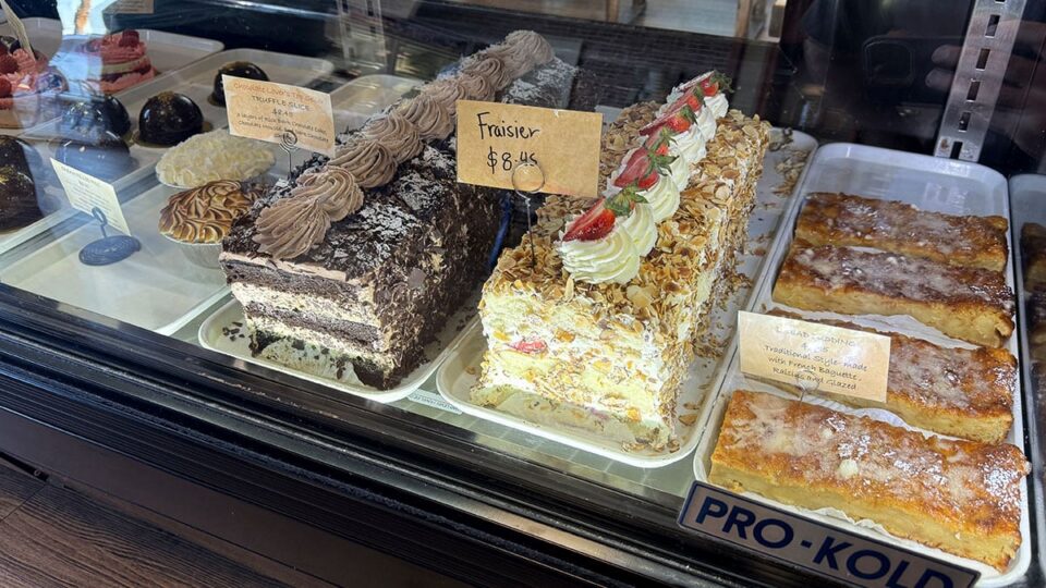 Assorted French cakes and pastries displayed inside Patisserie Manon bakery