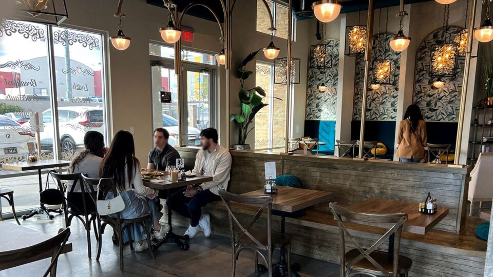 Dining room inside Le Café Central in Chinatown Las Vegas with tables and decorative lighting.