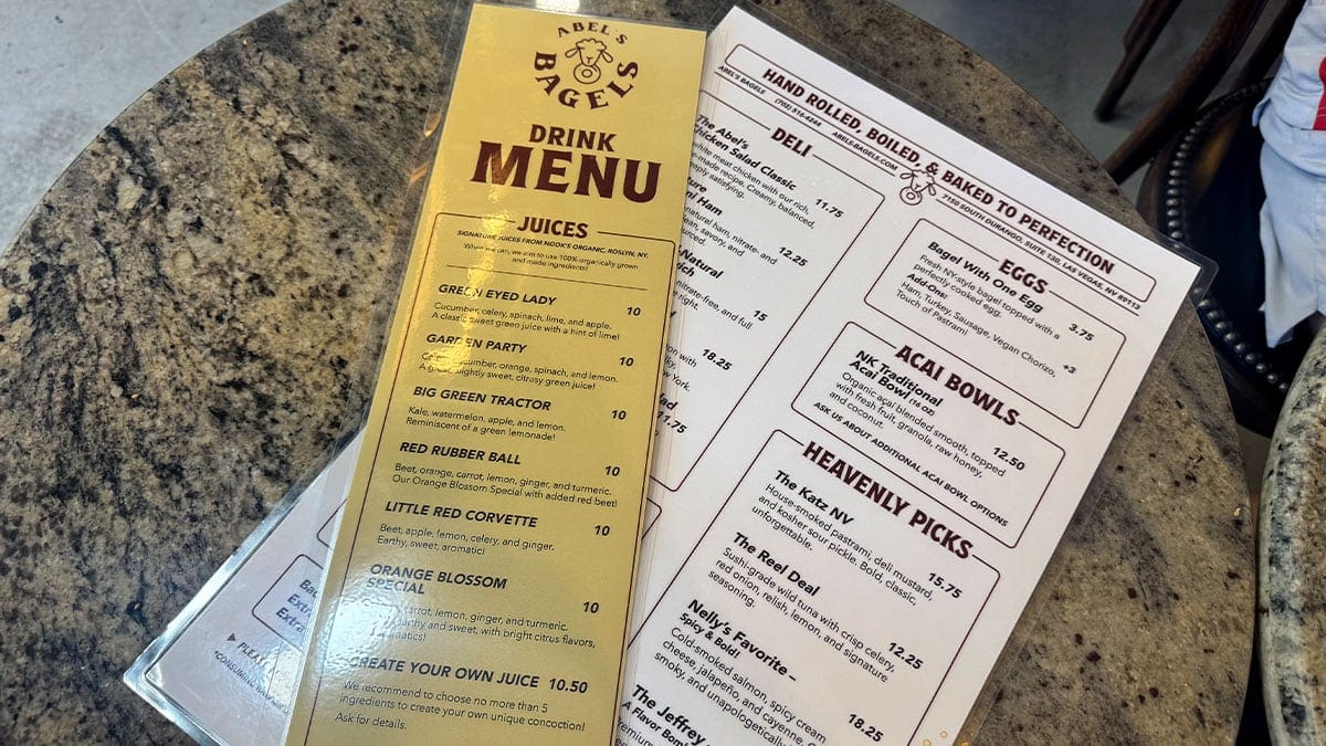 a menu display showing bagels, acai bowls, and smoothies at Abel’s Bagels