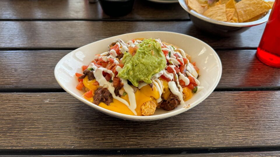 Loaded asada tater tots with nacho cheese, sour cream, avocado, and pico at Big T’s Cantina