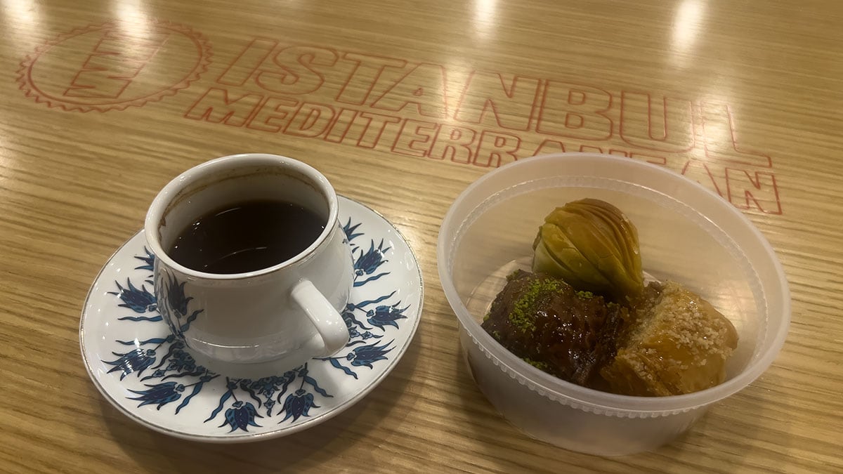 baklava pastries served alongside a cup of traditional turkish coffee on a table in a restaurant setting