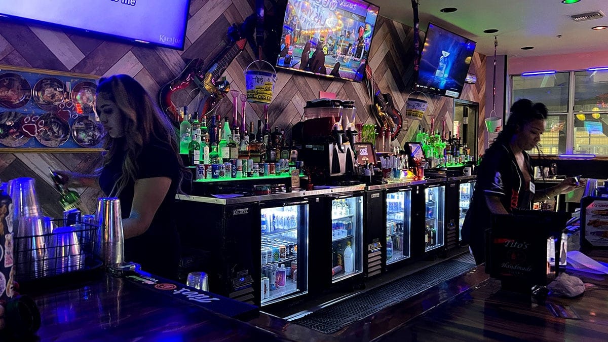 Bar area with drinks and seating inside Cat’s Meow karaoke bar in Downtown Las Vegas