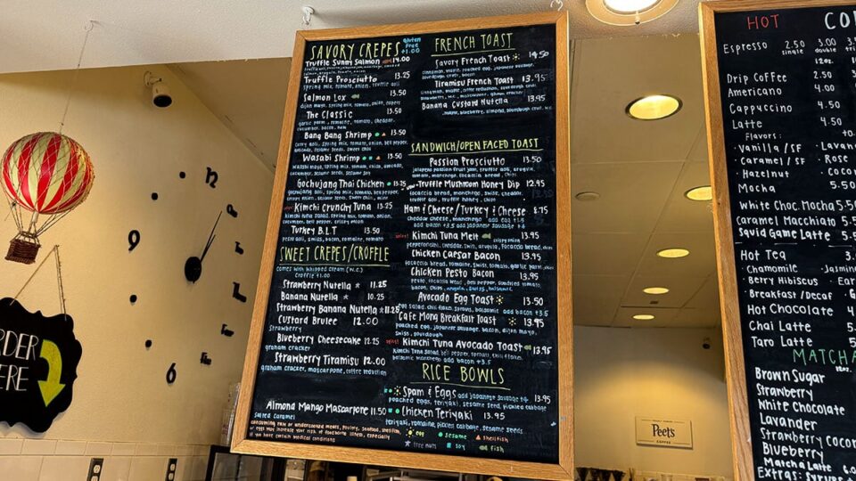 Cafe Mong menu board displayed above the ordering counter.