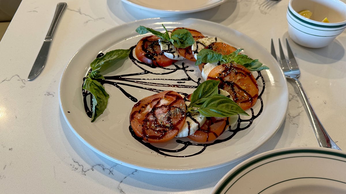 fresh caprese appetizer with tomatoes mozzarella basil and balsamic glaze at novella italian kitchen