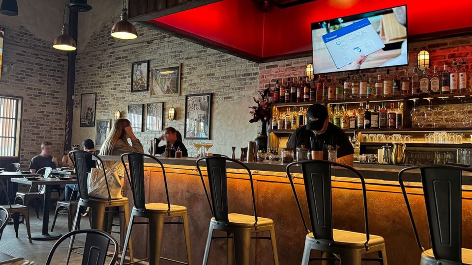 Bar area inside Double Zero Pie & Pub with guests and seating