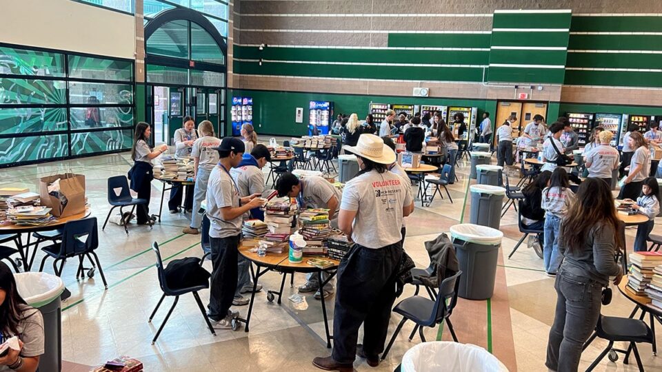 Group of volunteers cleaning and organizing books during service event
