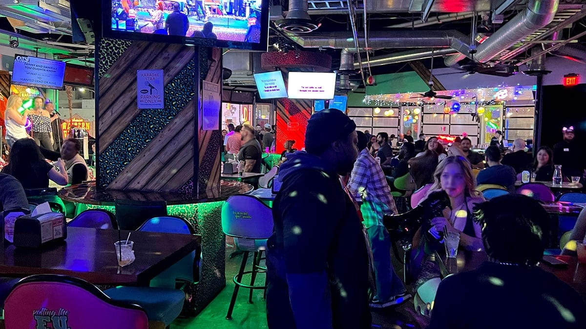 Guests enjoying drinks inside the lively and busy Cat’s Meow karaoke bar in Downtown Las Vegas