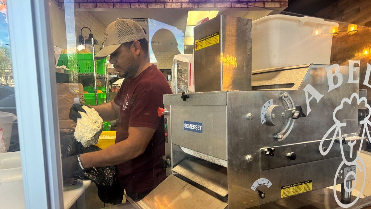 a close-up of fresh bagels being prepared at Abel’s Bagels
