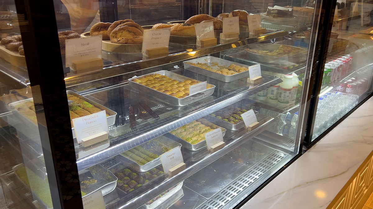a variety of turkish pastries arranged on a plate including baklava and other flaky desserts
