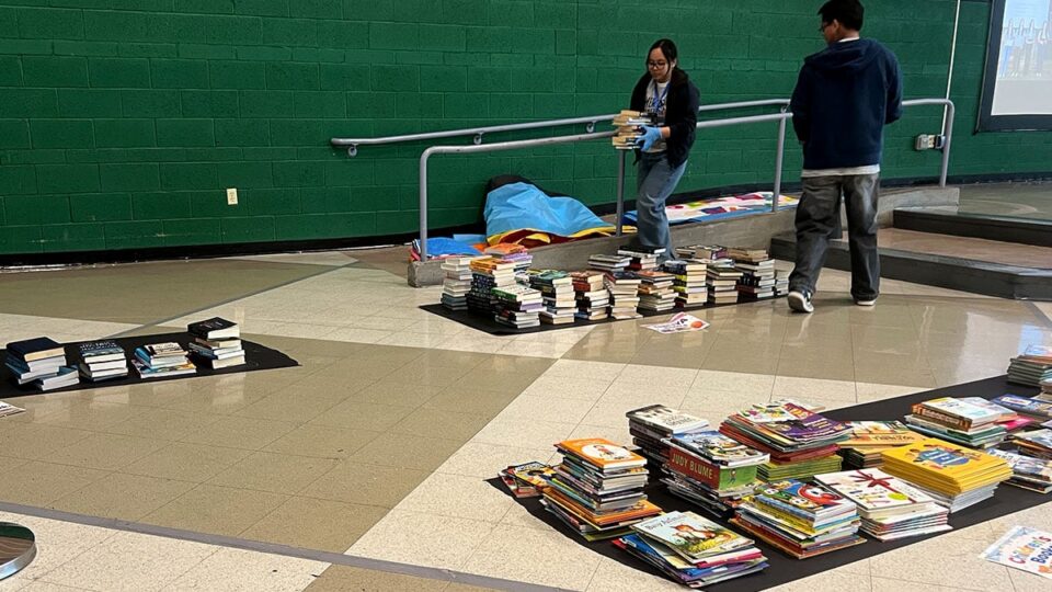 Stacks of donated books grouped together for distribution