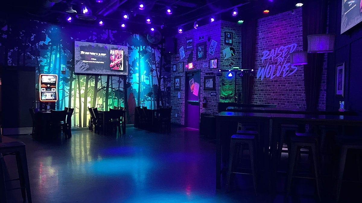 Seating area at Raised By Wolves featuring lounge-style tables and a lively downtown bar atmosphere.
