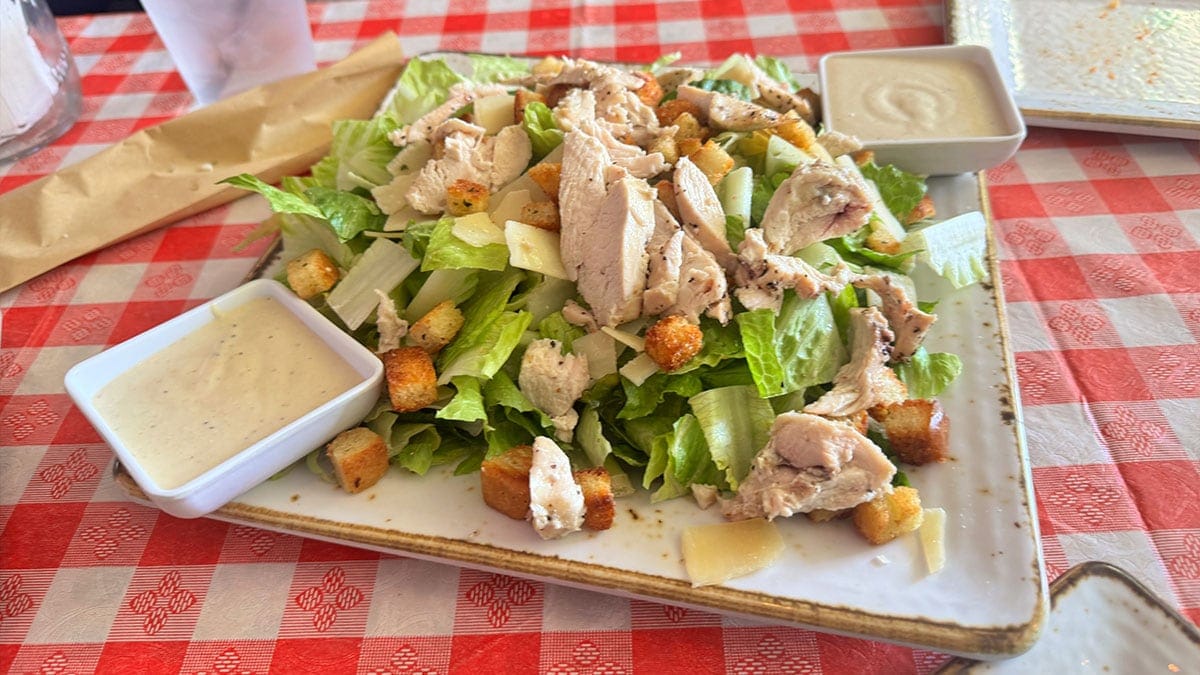 Chicken Caesar salad with grilled chicken, romaine lettuce, parmesan, and dressing at Santina’s New York Pizzeria.