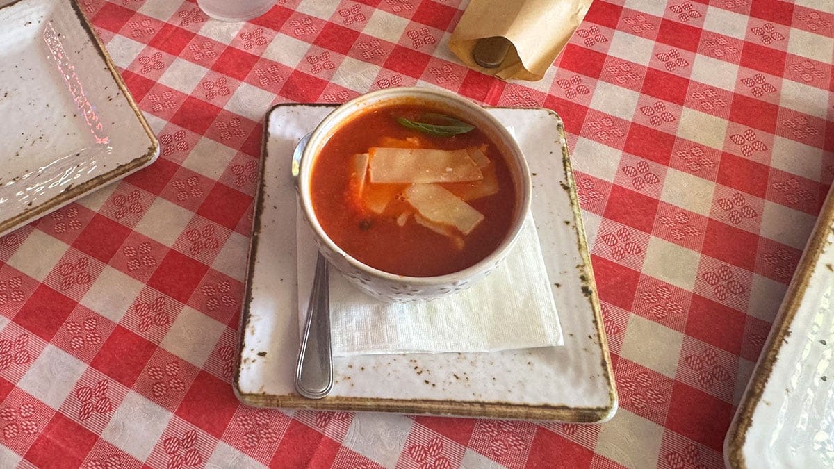 Bowl of tomato soup with a rich, creamy texture at Santina’s New York Pizzeria.