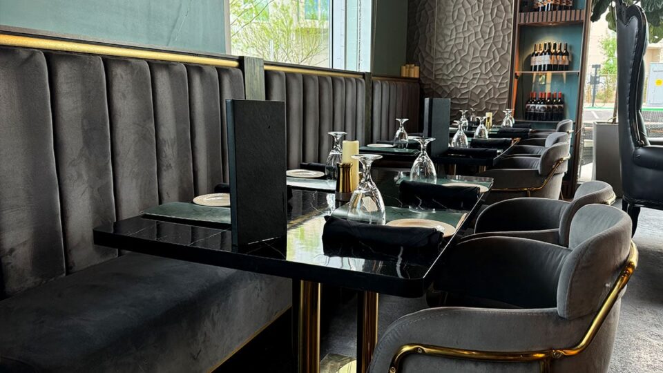 Velvet dining chairs with gold trim inside Rumi Room restaurant