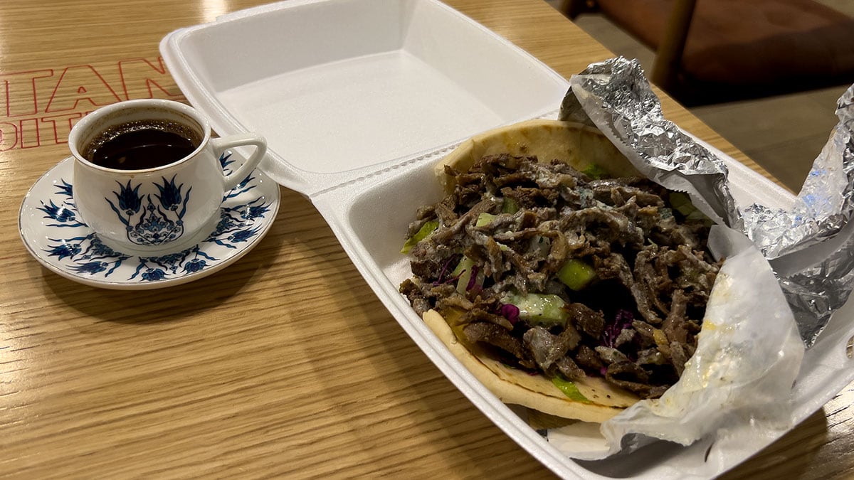 super beef gyros wrapped in soft pita bread filled with seasoned meat and toppings served on a plate