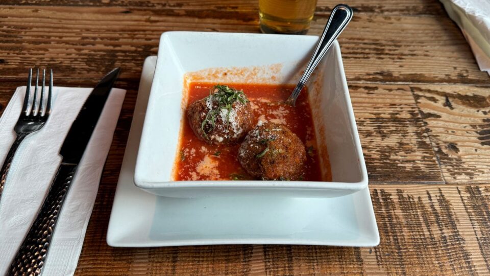 Crispy arancini rice balls with cheese peas and beef served at Settebello Pizzeria