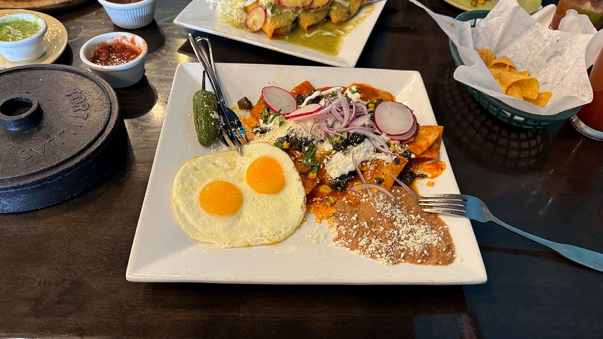 huitlacoche chilaquiles with eggs chorizo and toppings at chile caliente
