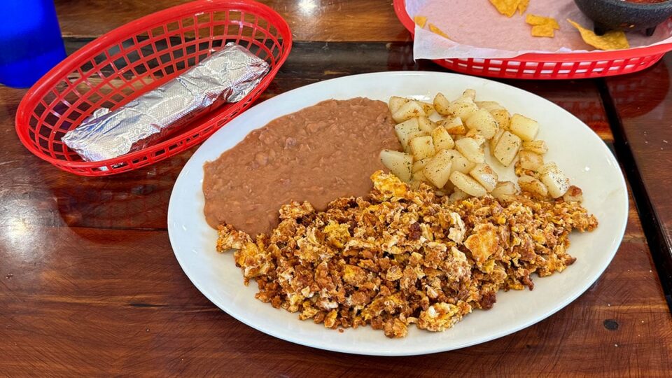 Chorizo con huevos served with potatoes, refried beans, and tortillas at El Zarape.