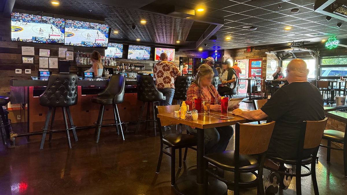Couple ordering lunch at Jonny Mac’s Water Street Tavern, standing at the bar in a casual and welcoming setting.