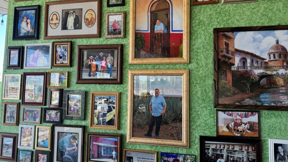 Family and heritage photos displayed on the wall inside El Zarape Family Restaurant.
