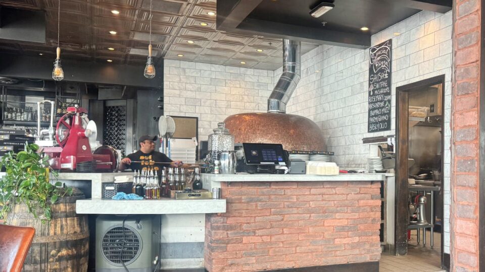 Wood fired pizza oven glowing inside Settebello Pizzeria Napoletana Las Vegas