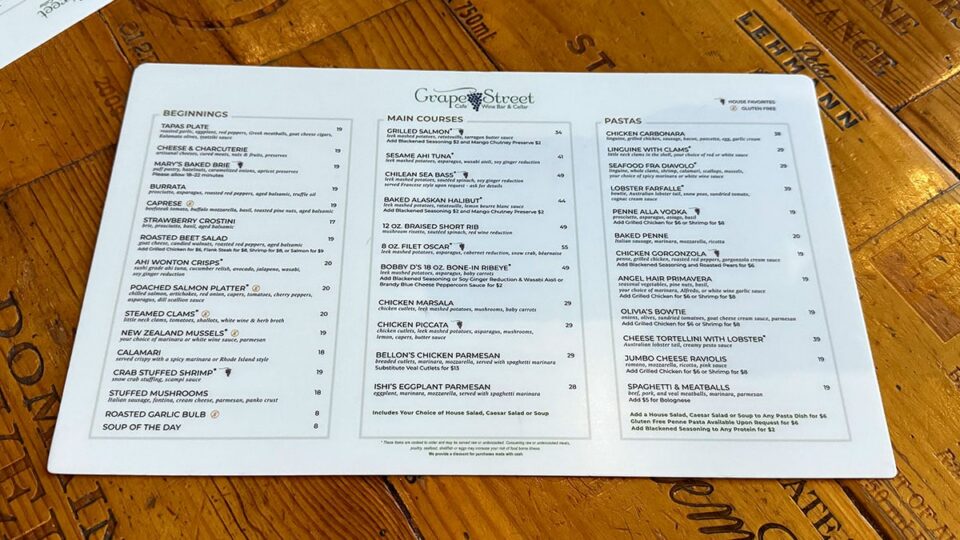 Menu display at Grape Street Wine Bar featuring pasta, salads, and wine selections