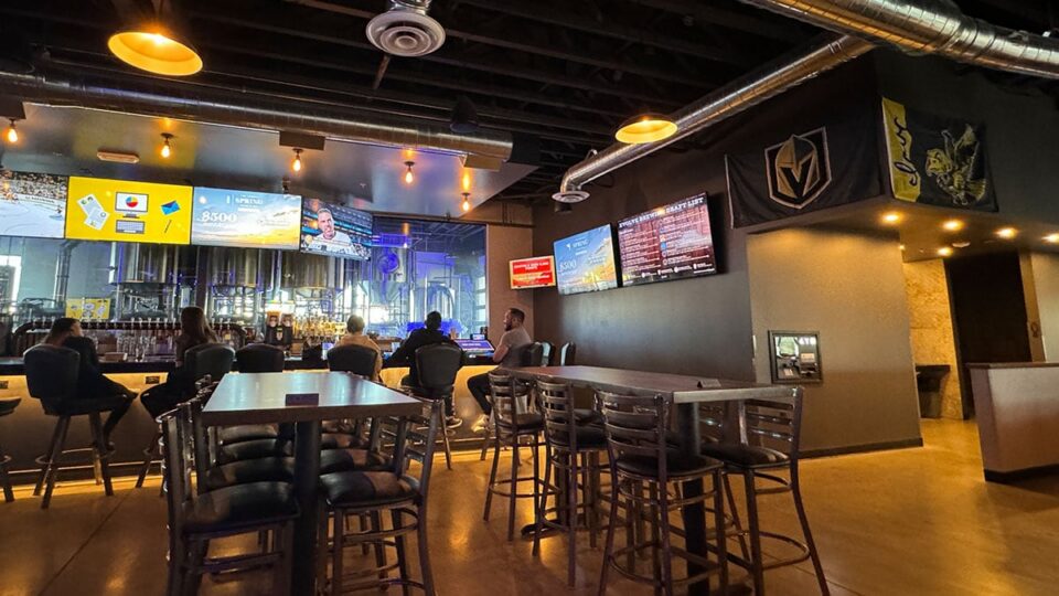 High top tables, bar seating, and booths inside Evolve Brewing Project.