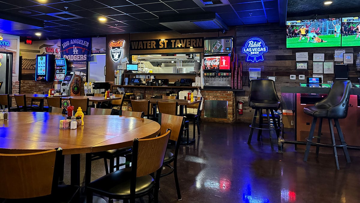 Inside view of Jonny Mac’s Water Street Tavern showing a lively bar interior with seating, TVs, and a casual, welcoming atmosphere.