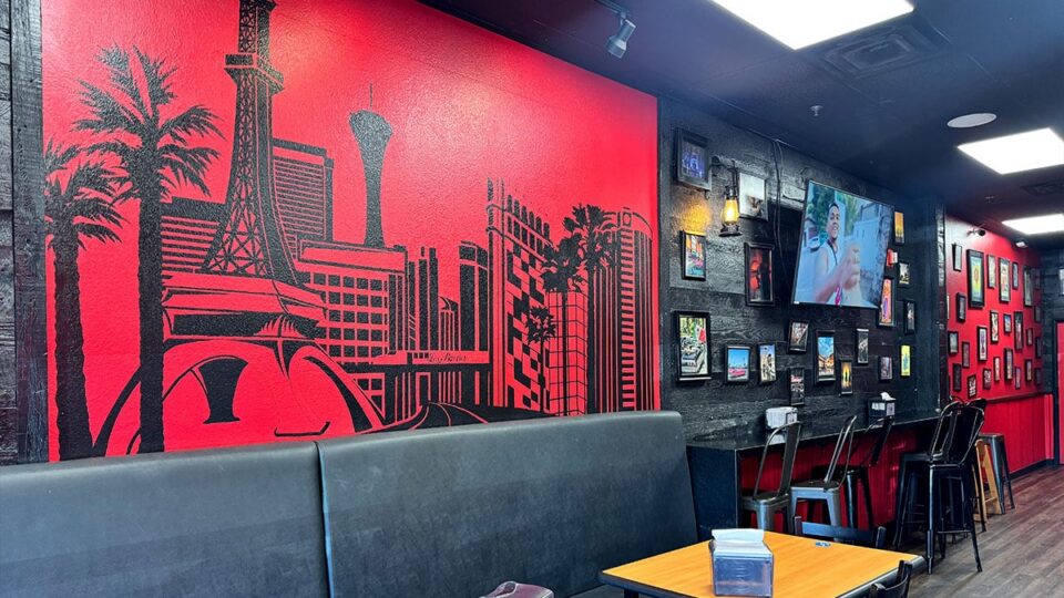 Bright red Las Vegas mural painted on the wall inside Tacos Los Barrios.