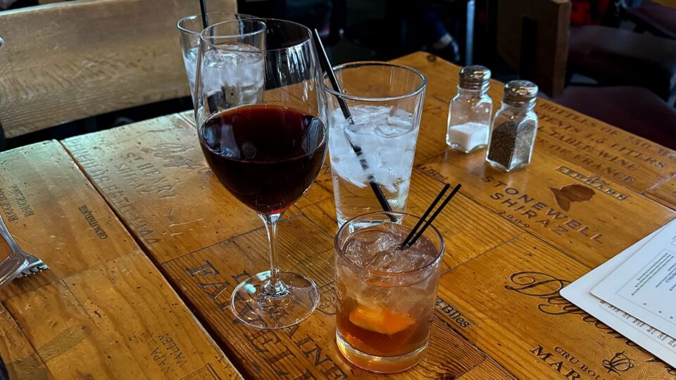 Glass of Pinot Noir next to an Old Fashioned cocktail at Grape Street Wine Bar