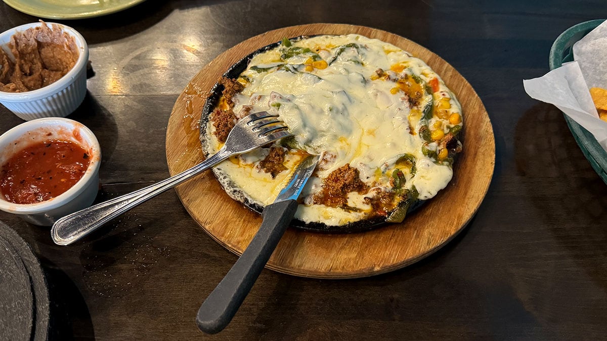 melted queso fundido with poblano peppers and tortillas at chile caliente