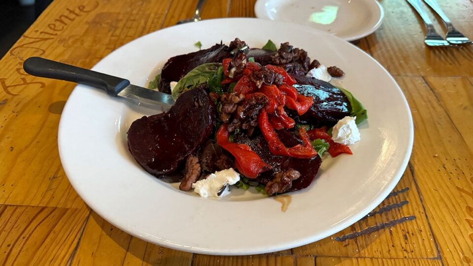 Roasted beet salad with goat cheese, candied walnuts, and balsamic dressing