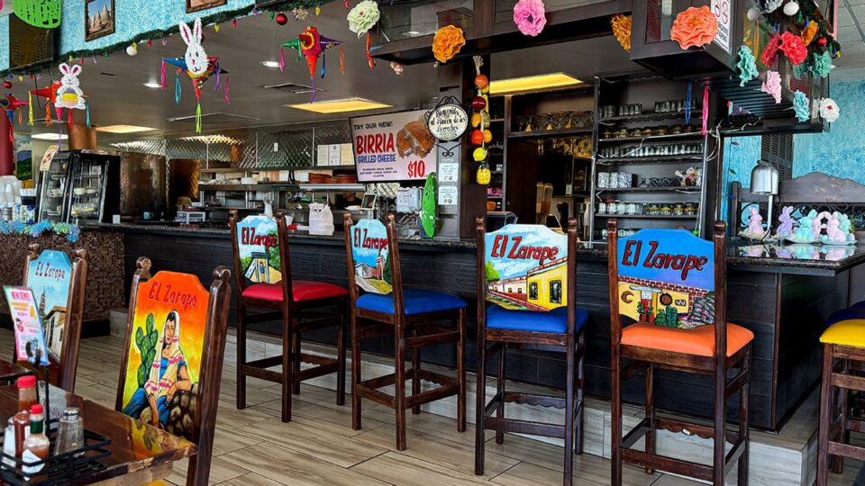 Bright and colorful bar seating area inside El Zarape Family Restaurant.