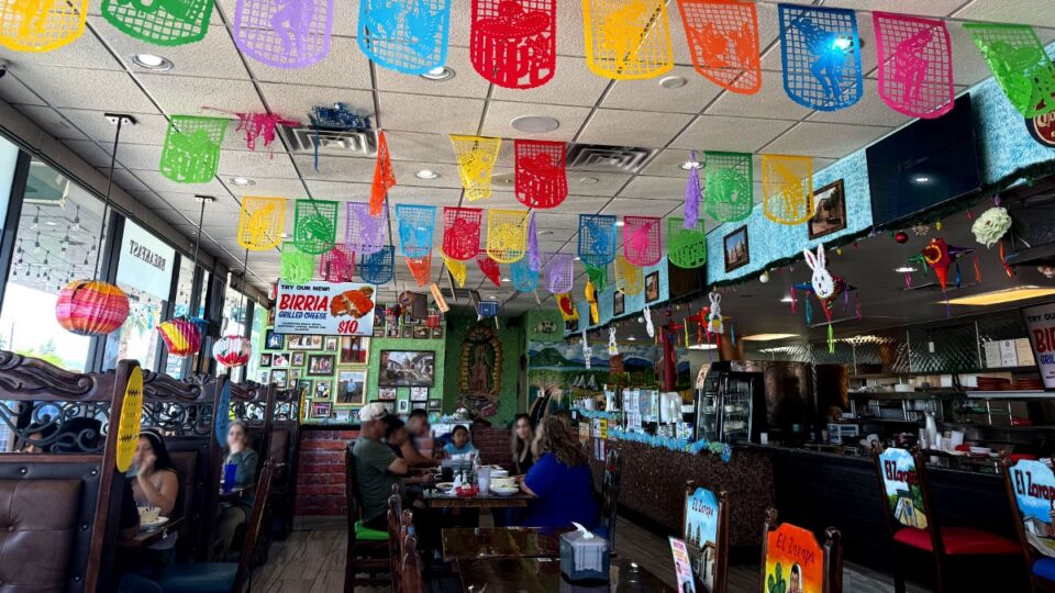 Vibrant interior of El Zarape featuring colorful decor, wooden furniture, and traditional Mexican touches.