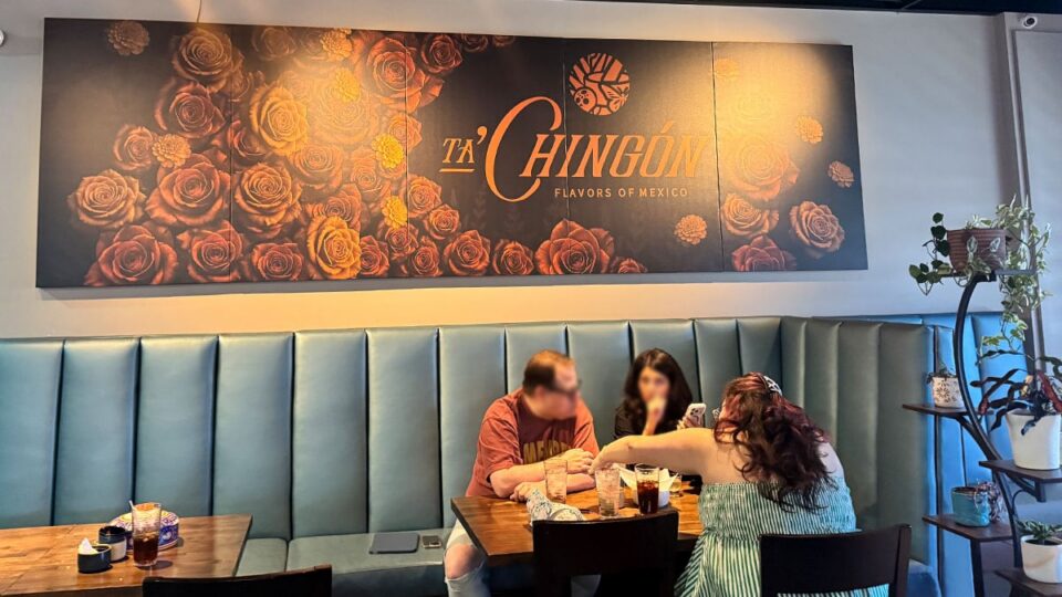 Guests enjoying lunch beneath the Ta’Chingón sign inside the restaurant in Las Vegas.