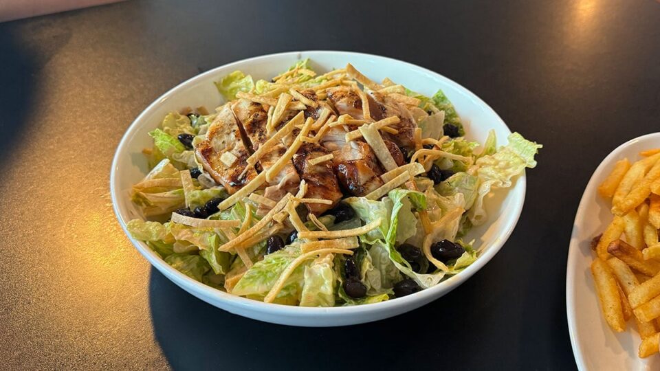 BBQ chicken salad with romaine, black beans, corn, and crispy tortilla strips at Sticks Tavern