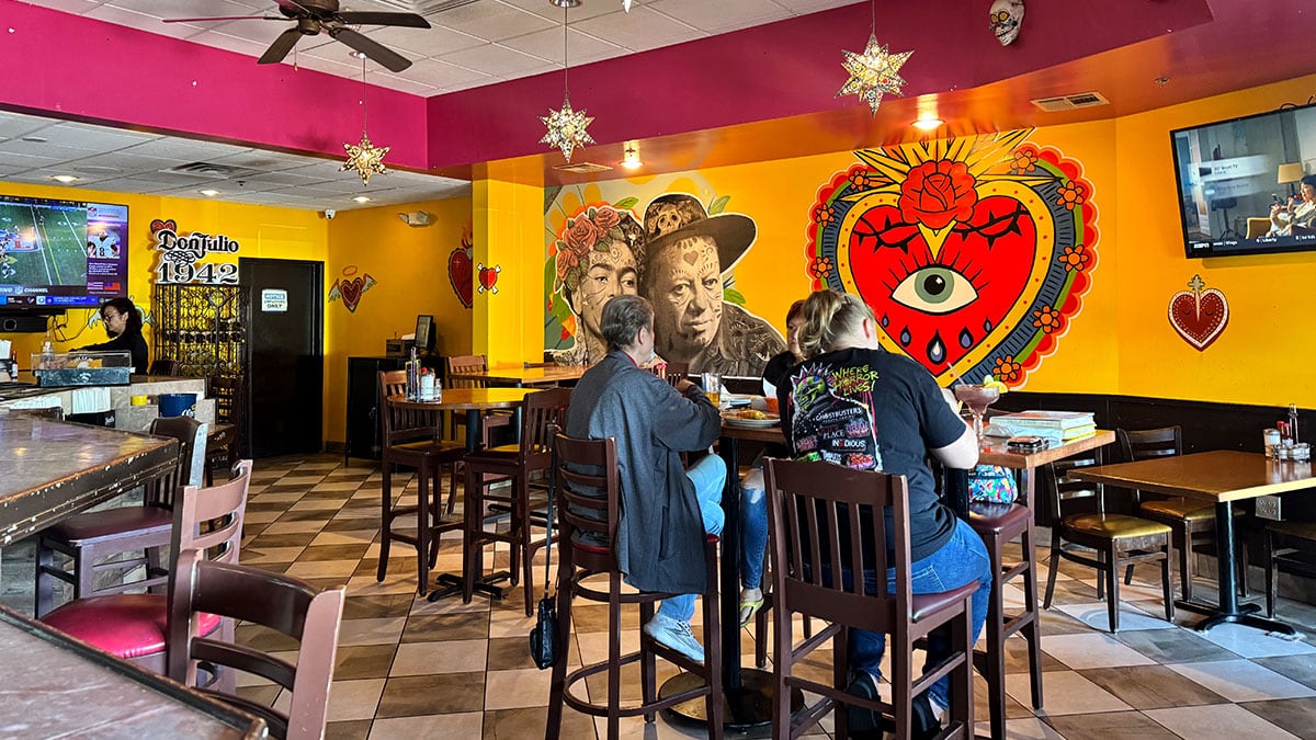 full bar area inside Casa Don Juan with seating and festive decor
