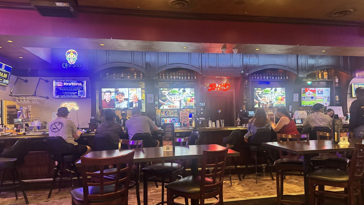 lively bar area filled with guests inside Bogey’s Bar & Grill West