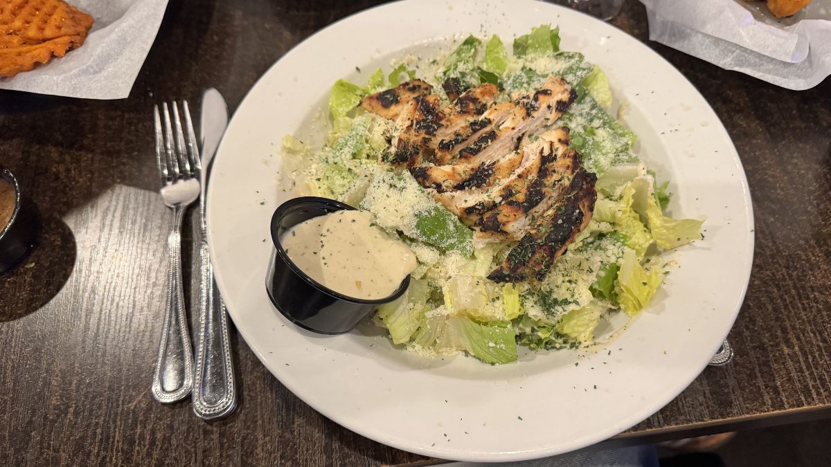 grilled chicken caesar salad served at Bogey’s Bar & Grill West