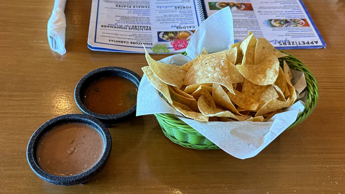 complimentary chips and salsa with a side of beans at Casa Don Juan