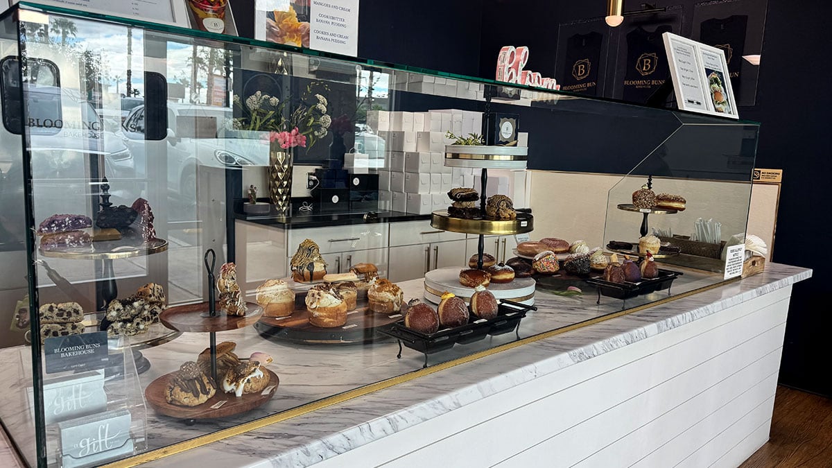 display case filled with brioche doughnuts and desserts at blooming buns bakehouse