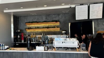 Coffee drinks and food items displayed at the counter inside Aware Coffee.