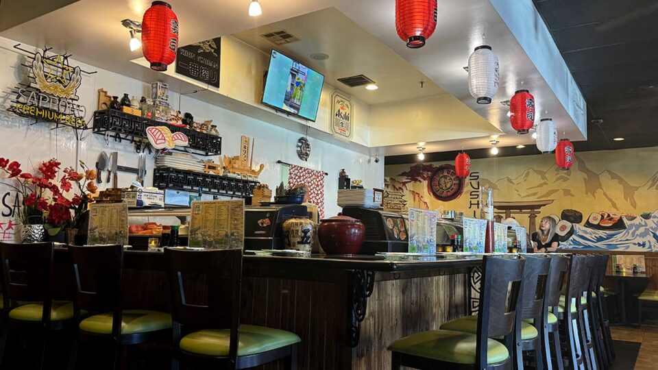 The interior bar seating area at Sasa Sushi featuring traditional Japanese decor and a relaxed atmosphere.